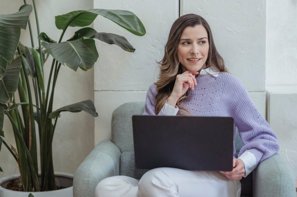 Professional woman working on a laptop showcasing Filip Digital's website design services