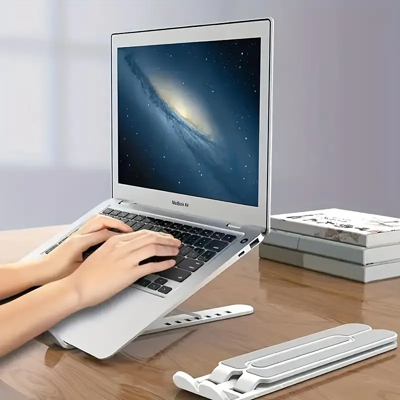 Ergonomic Adjustable Laptop Stand made of lightweight ABS material, foldable design, fits 30.48cm to 39.62cm laptops, enhances cooling and comfort